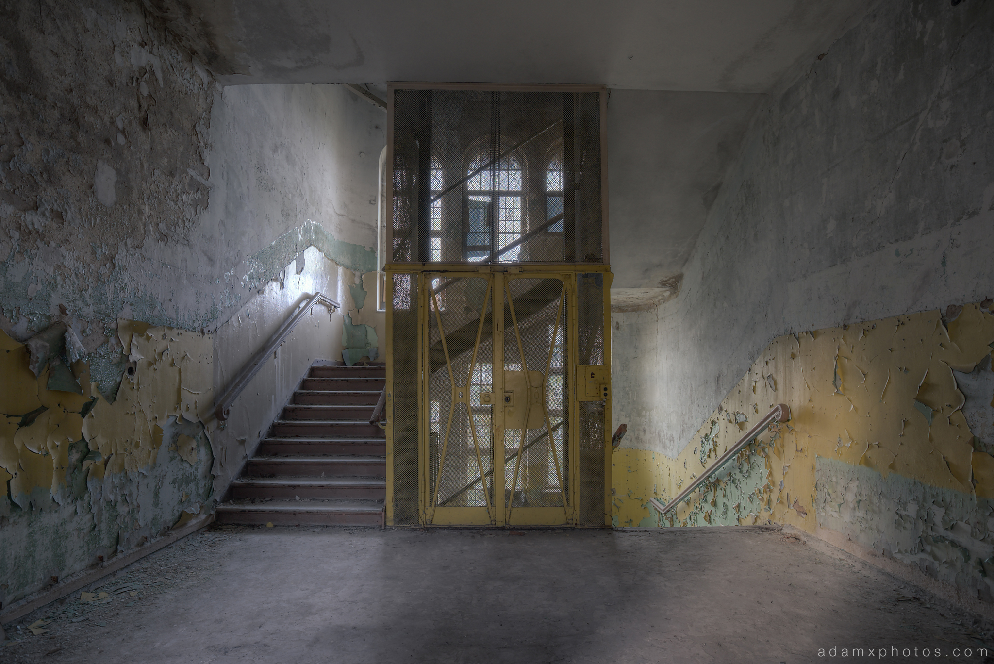 Adam X Urbex Heilstatten Hohenlychen Germany Urban Exploration Decay Lost Abandoned Hidden lift staircase ornate windows peeling paint colours sanatorium