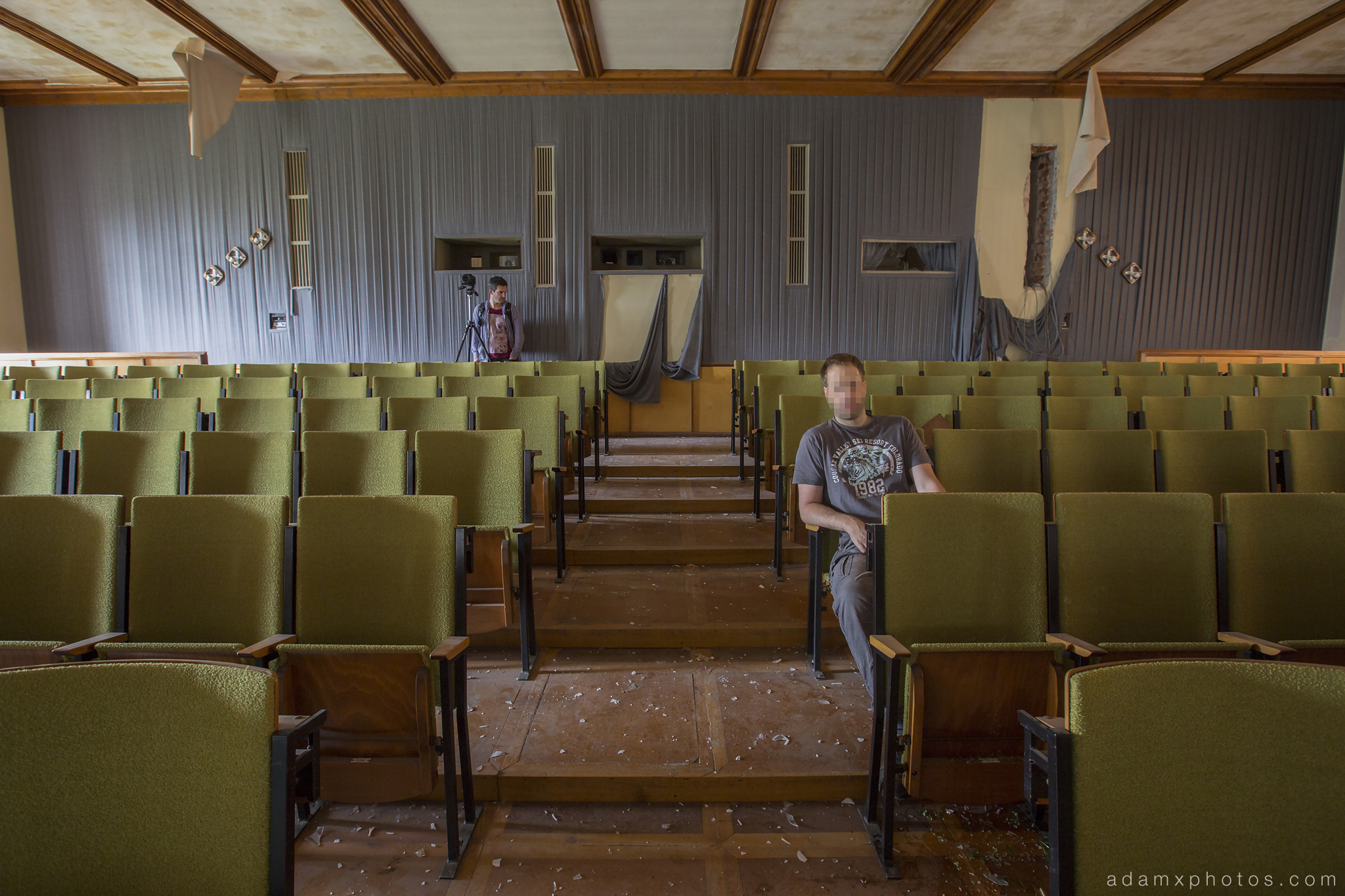 Adam X Urbex Nazi School Partishule N DDR Horsaal Germany Urban Exploration Decay Lost Abandoned auditorium ceiling seats chairs stage selfie James Kerwin